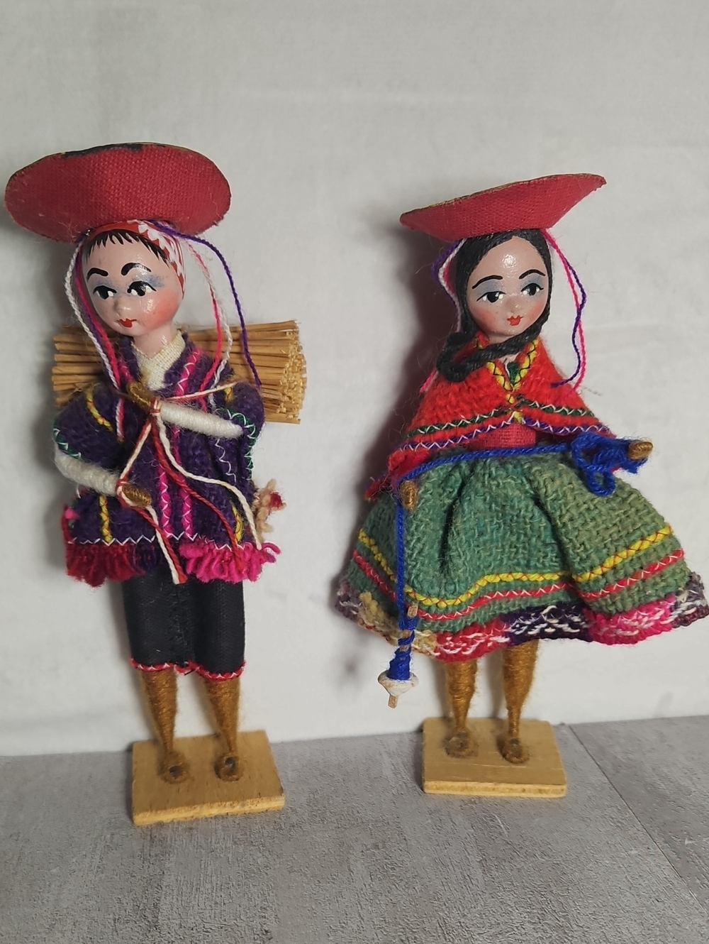 vintage handmade Peruvian folk art souvenir dolls mounted on small wooden bases.